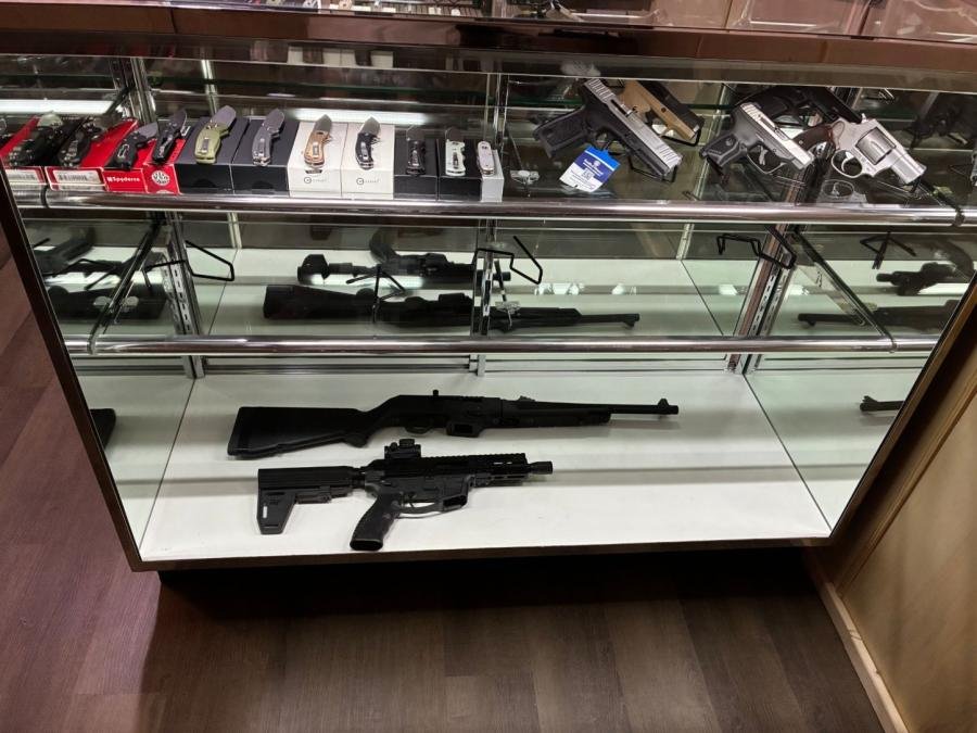Display case with knives, handguns, and rifles