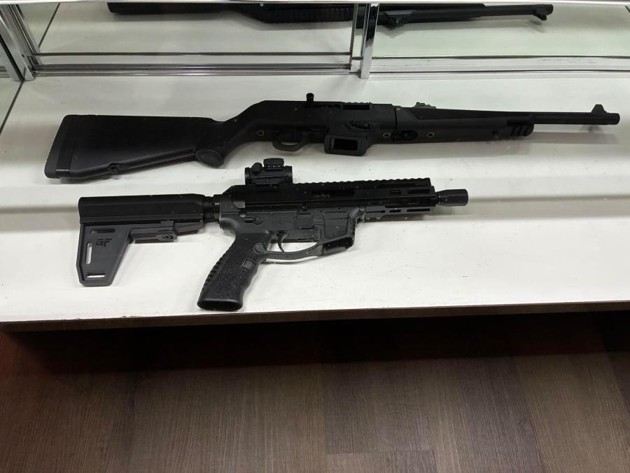 Two rifles laid in the display case